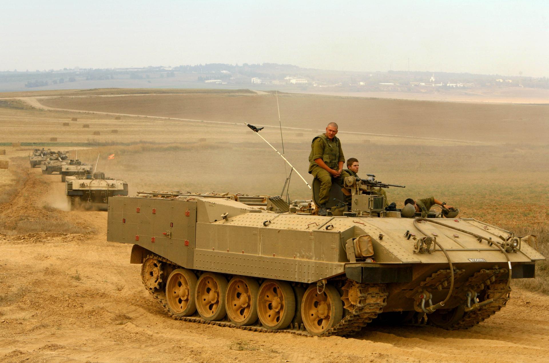 An Israeli tank convoy prepares to enter the Gaza Strip from Nizmit Hill, on the border with the Gaza Strip, on July 3, 2006. The army said it was a "limited" mission, aimed at finding explosives and tunnels near the border fence.