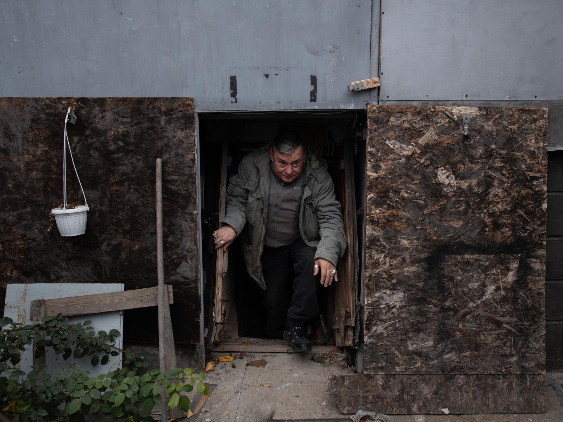 Safonov emerges from the shelter he has built in the basement of his house on the right bank of the Dnipro. Kherson (Ukraine), November 11, 2024.
