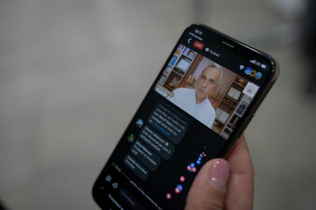 A woman watches a Calin Georgescu live stream on YouTube, in Bucharest, Romania, on November 25, 2024.