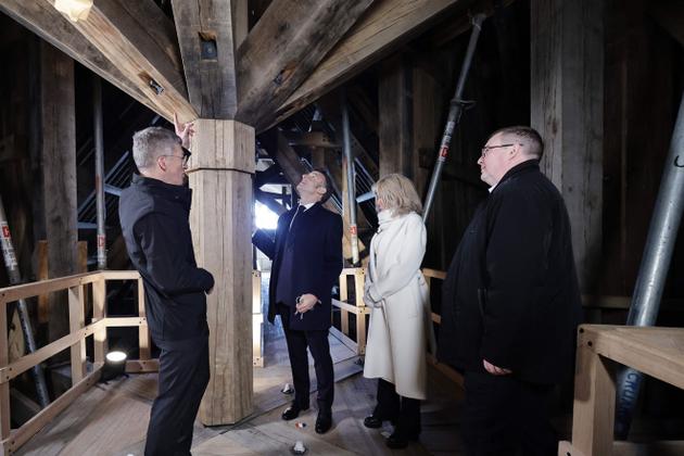 French President Emmanuel Macron (C-L) and his wife Brigitte Macron (C-R), accompanied by the president of the "Rebuilding Notre-Dame de Paris" public organization, Philippe Jost (L), visit the spire of Notre-Dame de Paris cathedral, in Paris, on November 29, 2024.