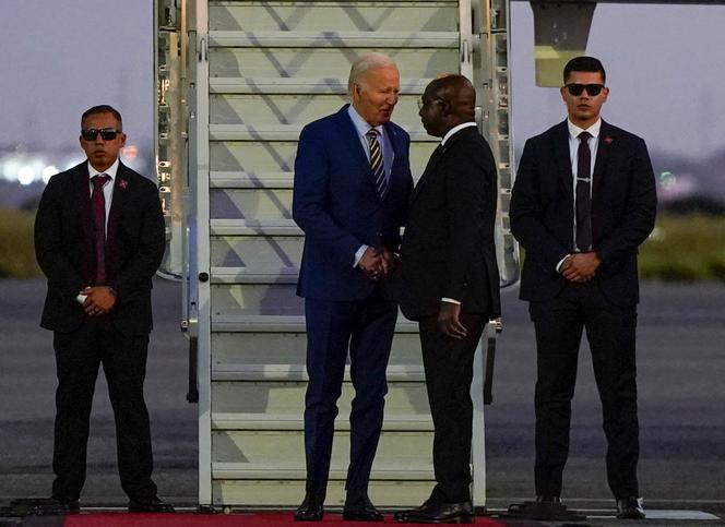 Le président des Etats-Unis, Joe Biden, salue le ministre angolais des affaires étrangères, Tete Antonio, à l’aéroport international de Luanda, le 2 décembre 2024.