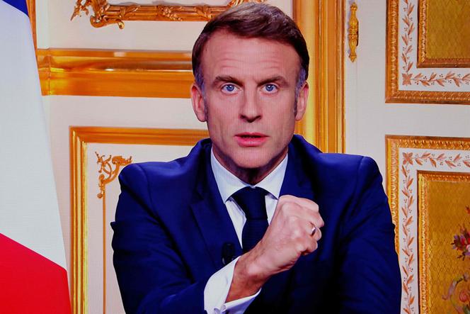 French President Emmanuel Macron is seen on monitors in a control room at Agence France-Presse headquarters as he addresses the nation during a televised broadcast from the presidential Elysée Palace, on the day of the prime minister's resignation on December 5, 2024.