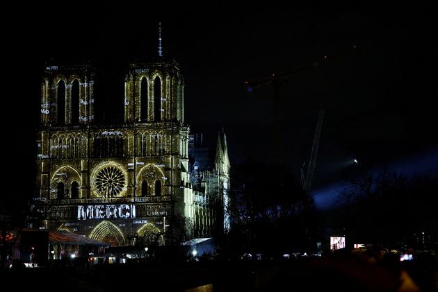 The word "merci" ("thank you") is seen on the facade of the Notre-Dame de Paris Cathedral.