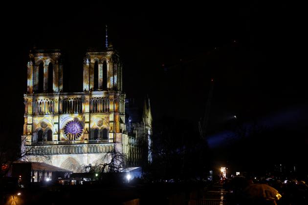 View of a light show on the facade of the Notre-Dame de Paris Cathedral.
