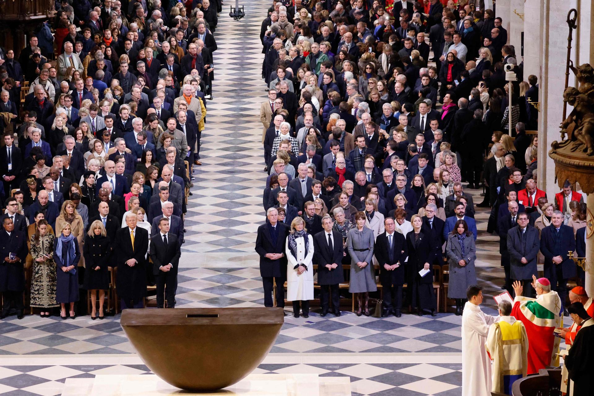 World leaders, politicians and guests stand as the Archbishop of Paris Laurent Ulrich reads during the  ceremony.