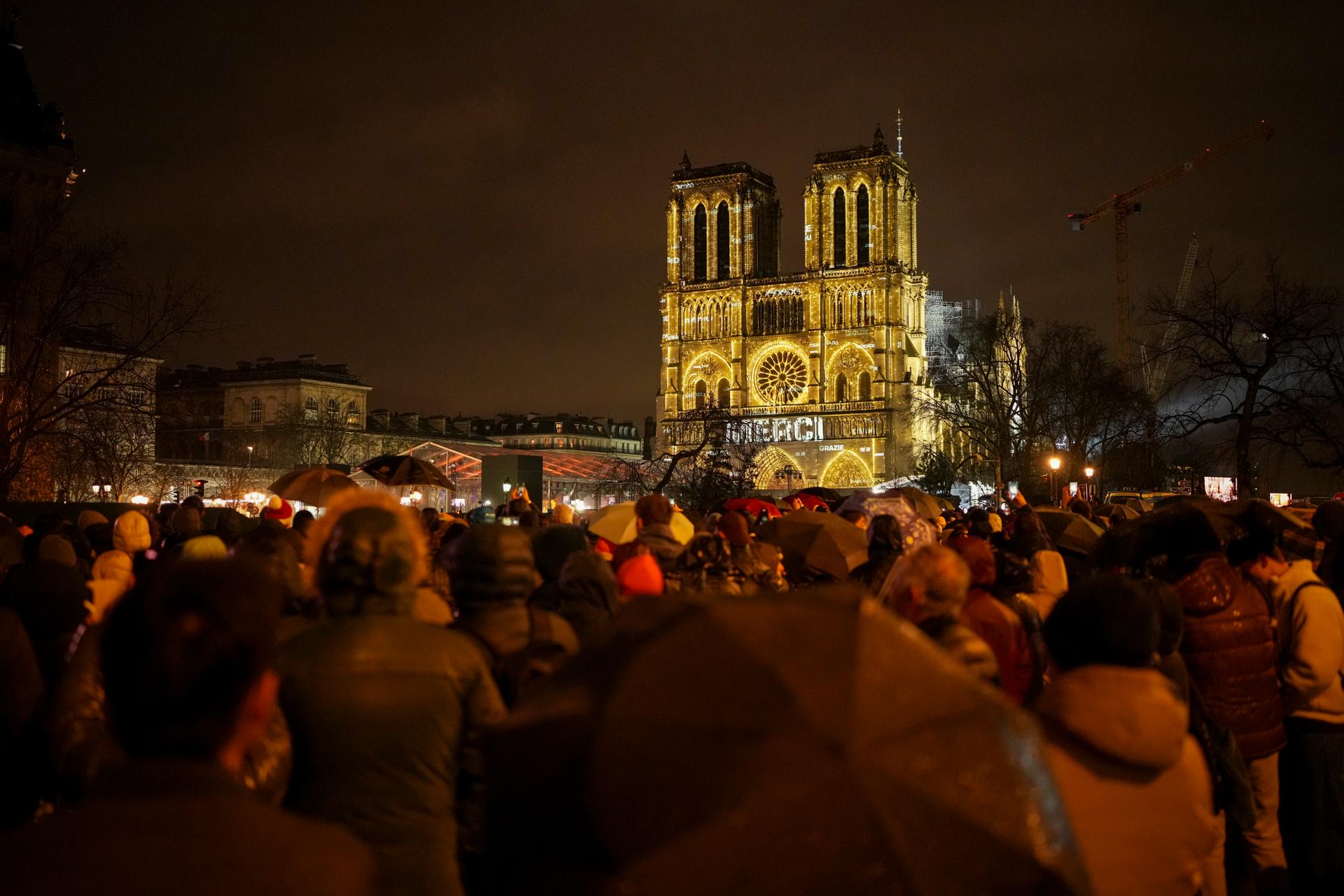 Spectators gather outside France's iconic Notre-Dame.
