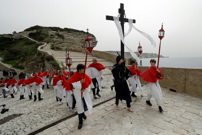 Faithful members of the Fraternité Saint-Barthélemy walk along the seafront promenade during Good Friday, as part of the Easter celebrations, in Bonifacio, Corsica, March 29, 2024.