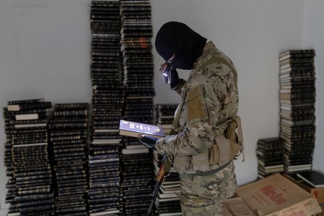 In the Assad home, a Hayat Tahrir Al-Sham (HTS) fighter, Damascus, December 11, 2024.