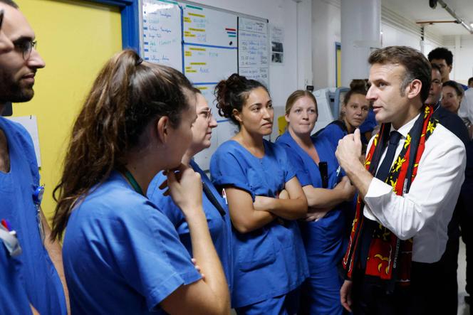 France's President Emmanuel Macron speaks with medical staff members of the intensive care unit of the Mayotte hospital center in Mamoudzou, on the French Indian Ocean department of Mayotte, on December 19, 2024.