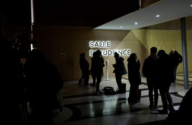 People standing in front of the Paris special criminal court, on December 20, 2024, ahead of the verdict against eight people linked to the murder of Samuel Paty in 2020.