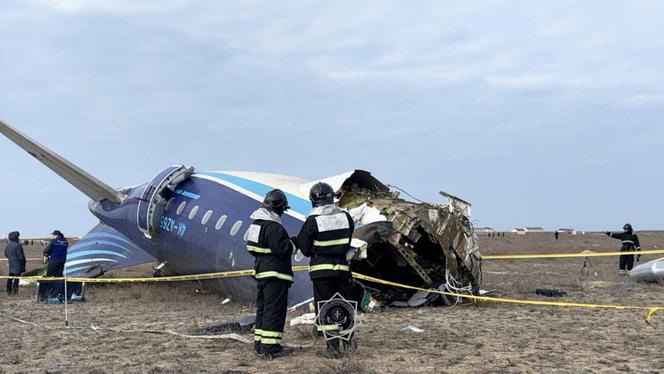 Emergency specialists work at the crash site of an Azerbaijan Airlines passenger plane near the city of Aktau, Kazakhstan December 25, 2024. 