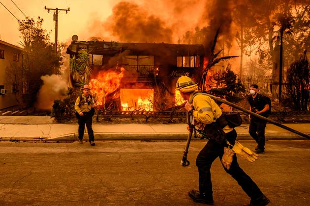 Firefighters attempt to extinguish a house fire in the Altadena area of Los Angeles County, California, on January 8, 2025.