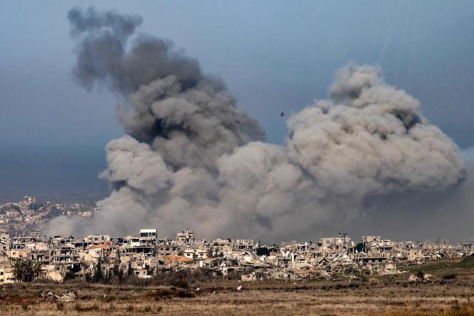 Cette photo prise du côté israélien de la frontière avec la bande de Gaza montre des explosions au-dessus des bâtiments détruits dans le nord de la bande de Gaza, le 13 janvier 2025.