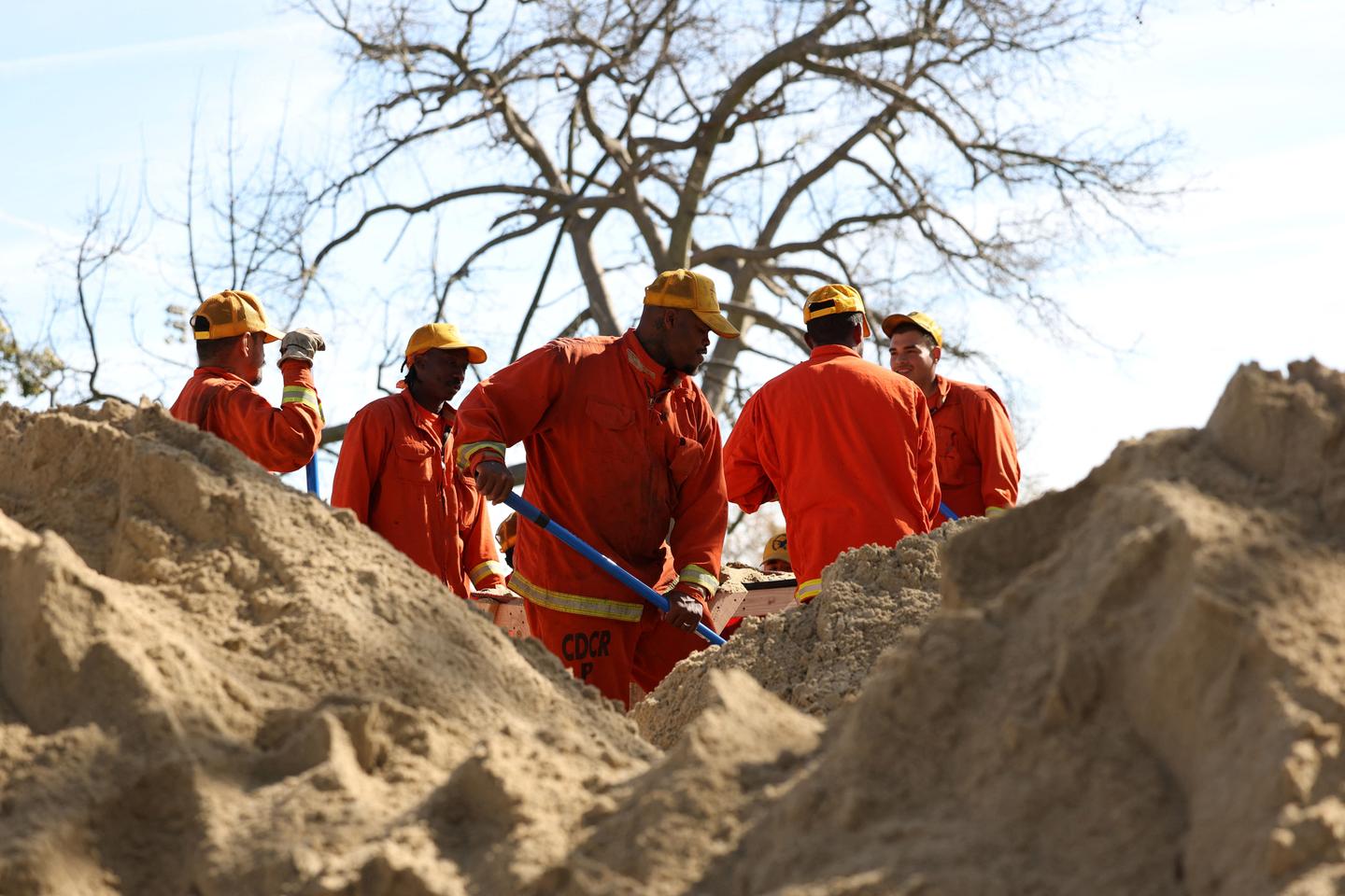 After weeks of wildfires, Southern California rain helps firefighters but creates risk of flooding and toxic ash runoff