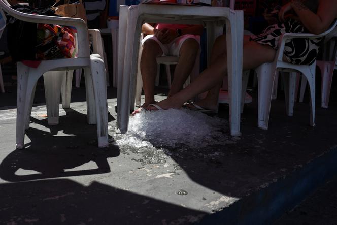 Un restaurateur a installé des pains de glace sous les tables pour accommoder ses clients lors d’une vague de chaleur, à Rio de Janeiro, le 25 janvier 2025. 