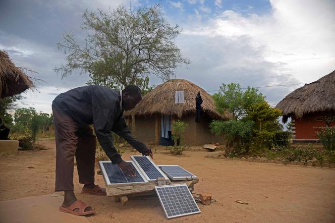 Installation de panneaux photovoltaïques dans le village d’Alaki, à quelque 300 kilomètres au nord-est de Kampala (Ouganda), en décembre 2016.