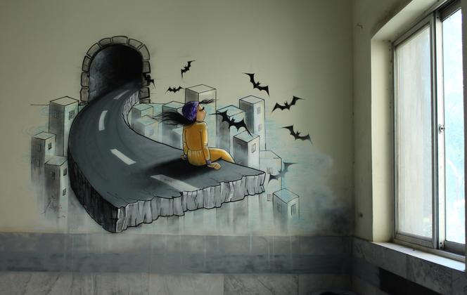 Graffiti sur le mur de l’université de Kaboul, retiré depuis quelques années, de l’artiste afghane Shamsia Hassani. 