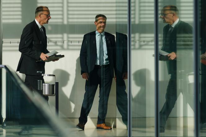 Friedrich Merz (left), leader of the Christian Democratic Union (CDU), arrives at a meeting at the Bundestag in Berlin, February 25, 2025.