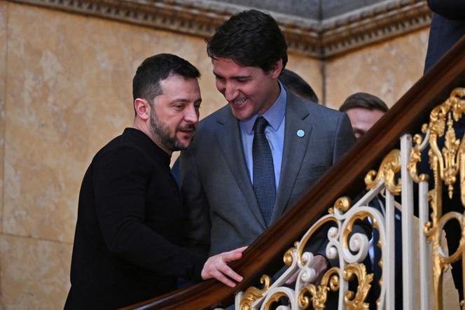 Ukraine's President Volodymyr Zelensky and Canada's Prime Minister Justin Trudeau speak on the stairs on their way to a plenary meeting at a summit held at Lancaster House in central London on March 2, 2025.