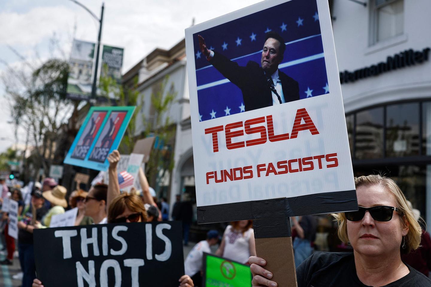 Protests against Musk's purge of US government swarm Tesla showrooms