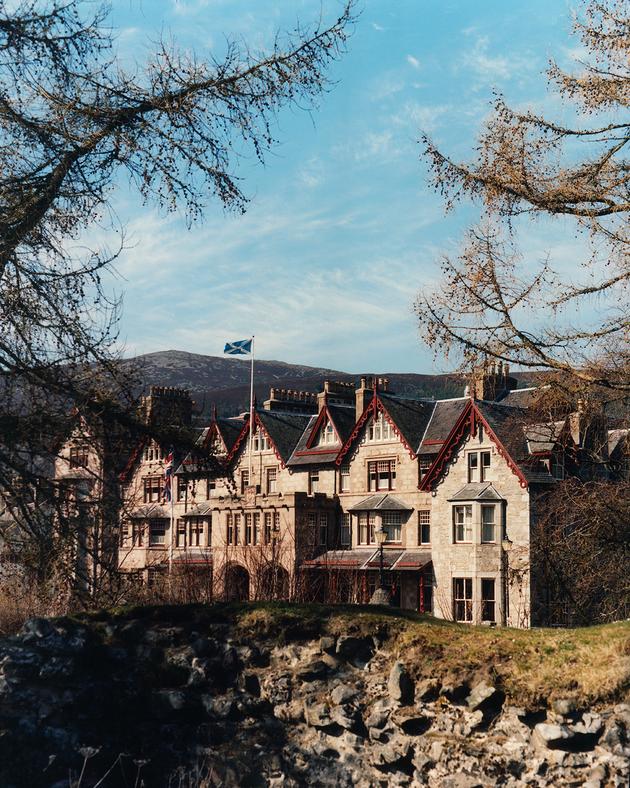 The façade of the Fife Arms Hotel seen from the ruins of Kindrochit Castle in Braemar, Scotland.