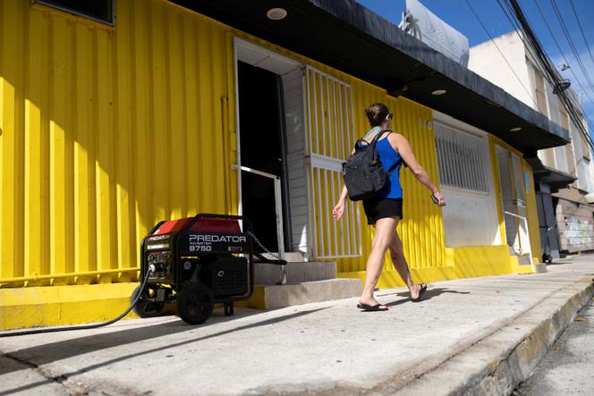 A woman walks to a restaurant driven by an energy generator after Puerto Rico was beaten with a mass blackout where energy plants on the island closed unexpected, in San Juan, Puerto Rico on April 16, 2025.