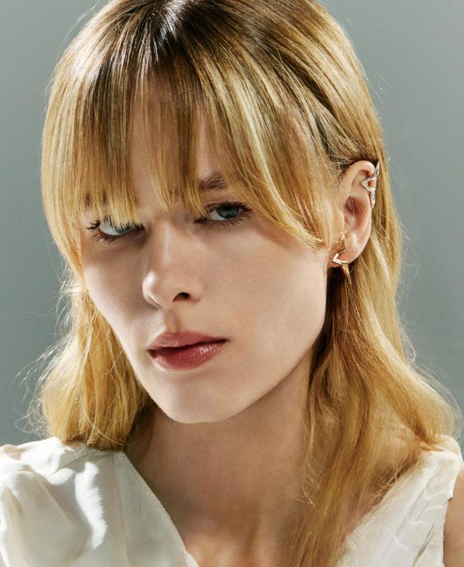 Bijou d’oreille Ombre Blossom, en or blanc et diamants, et créole superposée Ombre Blossom, en or rose et diamants, Louis Vuitton Joaillerie, prix sur demande. Robe Louis Vuitton.