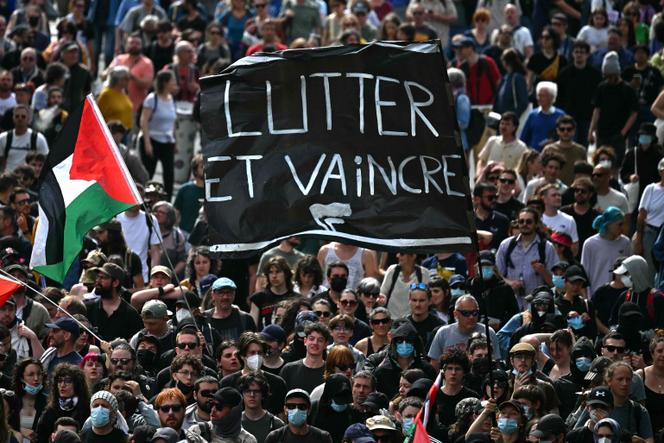 Protesters hold a banner during a 1ᵉʳ-May rally in Nantes, on May 1, 2025.