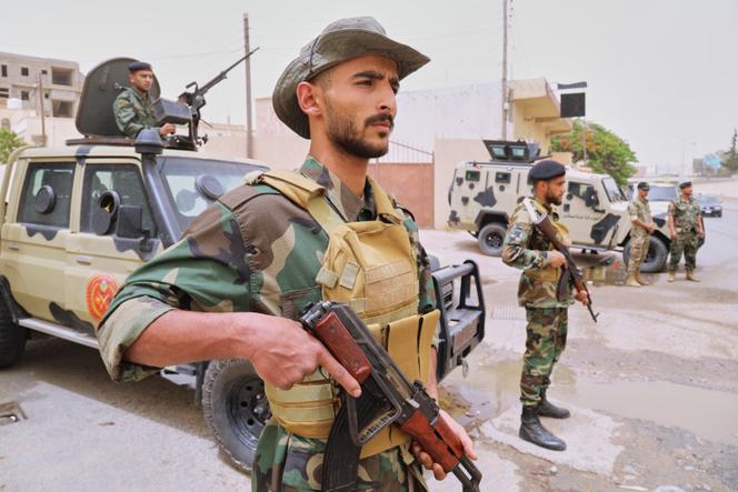 Un soldat libyen se tient en alerte à un poste de contrôle après des affrontements entre des milices lourdement armées, à Tripoli, en Libye, le 15 mai 2025.
