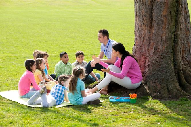 Des élèves et leurs professeurs en cours « dehors ».