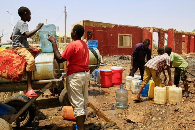 Des Soudanais remplissent des bidons d’eau potable à Khartoum, au Soudan, le 25 mai 2025.