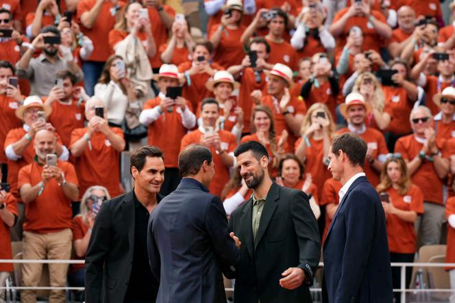 Roger Federer, Novak Djokovic and Andy Murray greet Rafael Nadal during a ceremony to honor his career on Court Philippe-Chatrier on May 25, 2025.