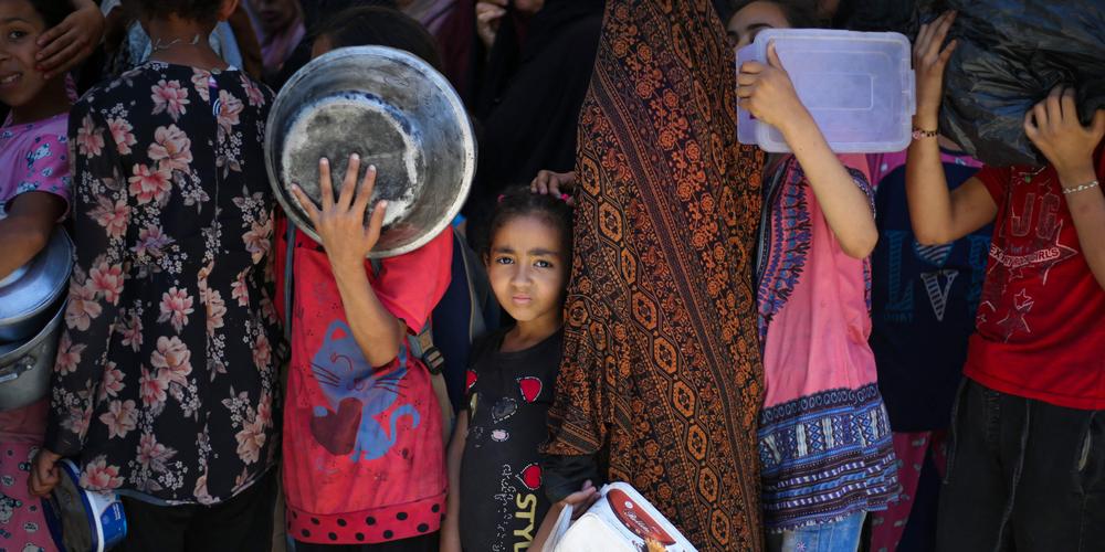 Des enfants palestiniens attendent avec d’autres personnes de la nourriture à un point de distribution à Nousseirat, au centre de la bande de Gaza, le 2 juin 2025. - EYAD BABA / AFP