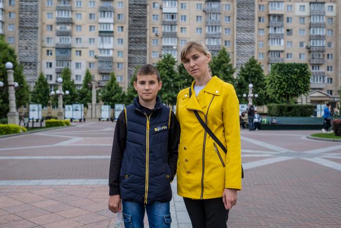 Viktoria Krykunova, 37, and her son Vlad, both from Svatove in the Luhansk oblast, in the central square of Irpin, Ukraine, on May 25, 2025.