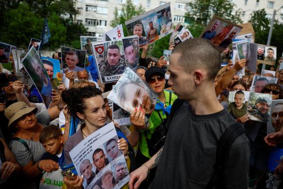 Ukraynalı askerler, 9 Haziran 2025'te Ukrayna'nın Chernihiv Oblastı'ndaki esaretten döndüklerinde yakınları tarafından gösterilen kayıp kişileri teşhis etmeye çalışıyor.