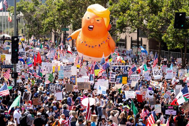 Demonstrators march in the 'No Kings' protest with a President Donald Trump balloon in Los Angeles on Saturday, June 14, 2025. 
