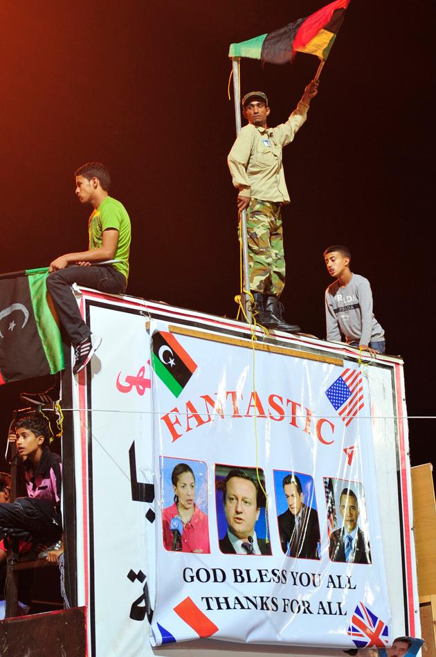 A poster saluting the operation launched in Libya by the US Ambassador to the United Nations Susan Rice, British Prime Minister David Cameron, French President Nicolas Sarkozy, and US President Barack Obama. In Benghazi, Libya, August 23, 2011