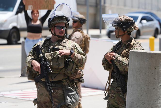 Des membres de la garde nationale de Californie et des marines américains montent la garde devant un bâtiment fédéral, mardi 17 juin 2025, à Los Angeles (Californie).