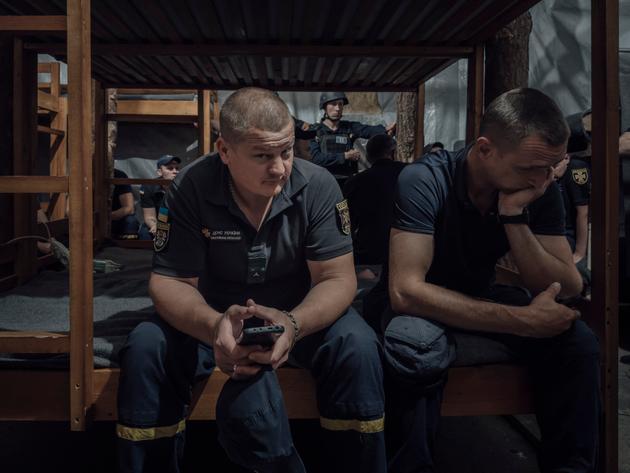 Firefighters take shelter in the basement of their base during bomb alerts, in Kostiantynivka, Ukraine, on June 11, 2025.