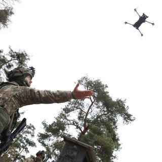 HOHENFELS, GERMANY - MARCH 12: A soldier of the Lithuanian Land Force prepares to catch a Parrot reconnaissance drone landing during the Allied Spirit 25 military exercise at the U.S. 7th Army Training Command Joint Multinational Readiness Center on March 12, 2025 near Hohenfels, Germany. Approximately 3,000 troops from NATO member countries, including the United States, Austria, the Czech Republic, France, Hungary, Italy, Spain, Latvia, Lithuania, North Macedonia, Slovakia, Slovenia and the United Kingdom, are participating in the four-week exercise with the aim of improving interoperability. European countries have pledged large-scale defence spending following doubts cast by the administration of U.S. President Donald Trump on the future of the U.S. commitment to the NATO military alliance. (Photo by Sean Gallup/Getty Images) (Photo by SEAN GALLUP / GETTY IMAGES EUROPE / Getty Images via AFP)