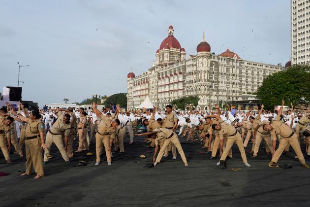 Security personnel practice yoga for International Yoga Day in Mumbai, on June 21, 2025.