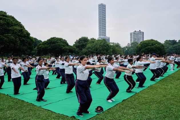 Schoolchildren practice yoga at Victoria Memorial in Kolkata, on June 21, 2025.