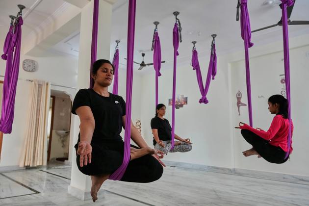 Women perform an exercise in a yoga studio in Hyderabad, India, on June 21, 2025.