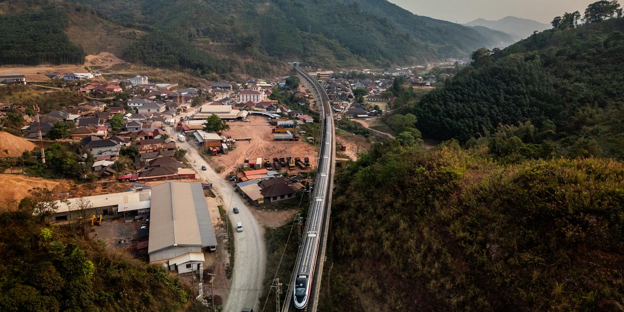 BOTEN, LAOS - APRIL 10: In an aerial view, the China-Laos Railway enters the Boten Special Economic Zone on April 10, 2024 in Boten, Laos. The Boten Special Economic Zone (SEZ), is a significant infrastructure project on the Laos border backed by a 10-billion-USD investment from China, was initially designed in 2003 and is set for completion in 2030. The SEZ is being built as an urban tourism and logistics hub. The China-Laos railway, a key project of China's Belt and Road Initiative, is a high-speed railway connecting Kunming, the capital of China's Yunnan province, to Vientiane, the capital of Laos. This railway is the biggest public infrastructure project ever undertaken by Laos, with a total length of 1,035 kilometers and a cost of US$5.9 billion, which is equivalent to around one-third of Laos' gross domestic product in 2019. The railway is dedicated to both passenger and freight traffic services, creating a new link between Laos and China, the former's neighbor and closest partner. The Laos section of the railway is part of a vision to build a Pan-Asia railway that will ultimately connect China, Laos, Thailand, Malaysia, and Singapore, improving the efficiency of goods movement for export-driven economies along the route, opening up travel and extending China's influence deep into Southeast Asia. (Photo by Lauren DeCicca/Getty Images) (Photo by Lauren DeCicca / GETTY IMAGES ASIAPAC / Getty Images via AFP)