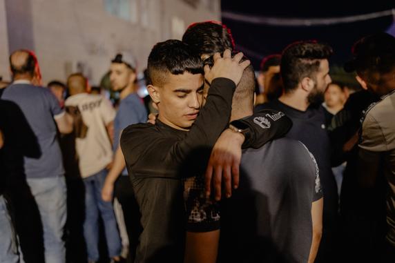 Youths mourn their relative killed in Kafr Malik during the Israeli settler attack, at Ramallah hospital (West Bank), June 25, 2025.