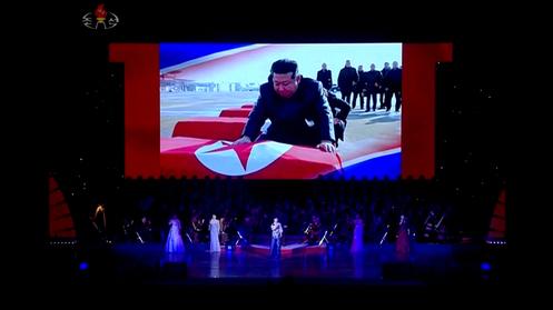 A screenshot shows a video of the North Korean leader, Kim Jong-un, covering coffins of North Korean flags, in Pyongyang, on June 29, 2025.