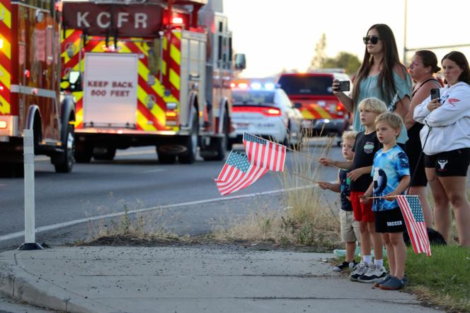 A procession from Kootenai Health headed to Spokane after a few firefighters were killed Sunday, June 29, 2025, when they were ambushed by sniper fire while responding to a blaze in a northern Idaho mountain community, in Coeur d’Alene, Idaho.
