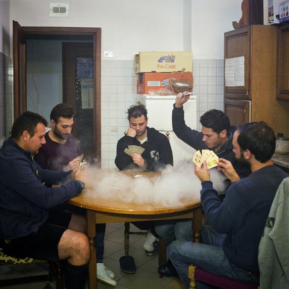 A group of friends playing cards in Zafferana Etnea, in the province of Catania (2019).