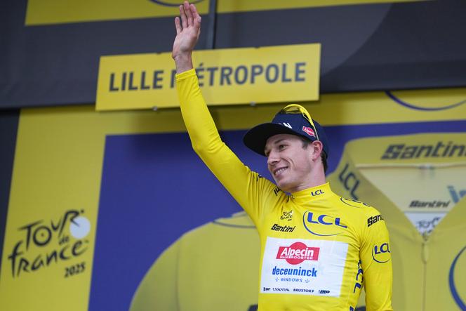 Belgium's Jasper Philipsen wearing the overall leader's yellow jersey celebrates on the podium after winning the first stage of the Tour de France cycling race over 184.9 kilometers (114.9 miles) with start and finish in Lille, France, Saturday, July 5, 2025.