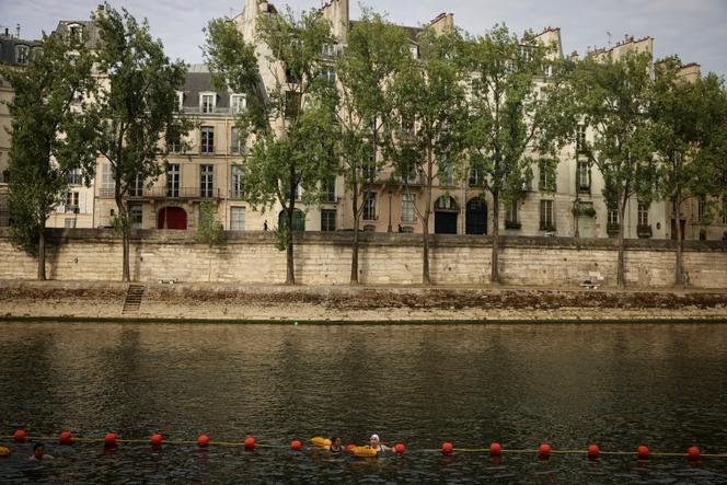 People swim at the Bras Marie safe bathing site on the Seine river in Paris, France, Saturday, July 5, 2025, during the opening of the three Seine swimming pools, as part of the 'Paris Plages' event. 